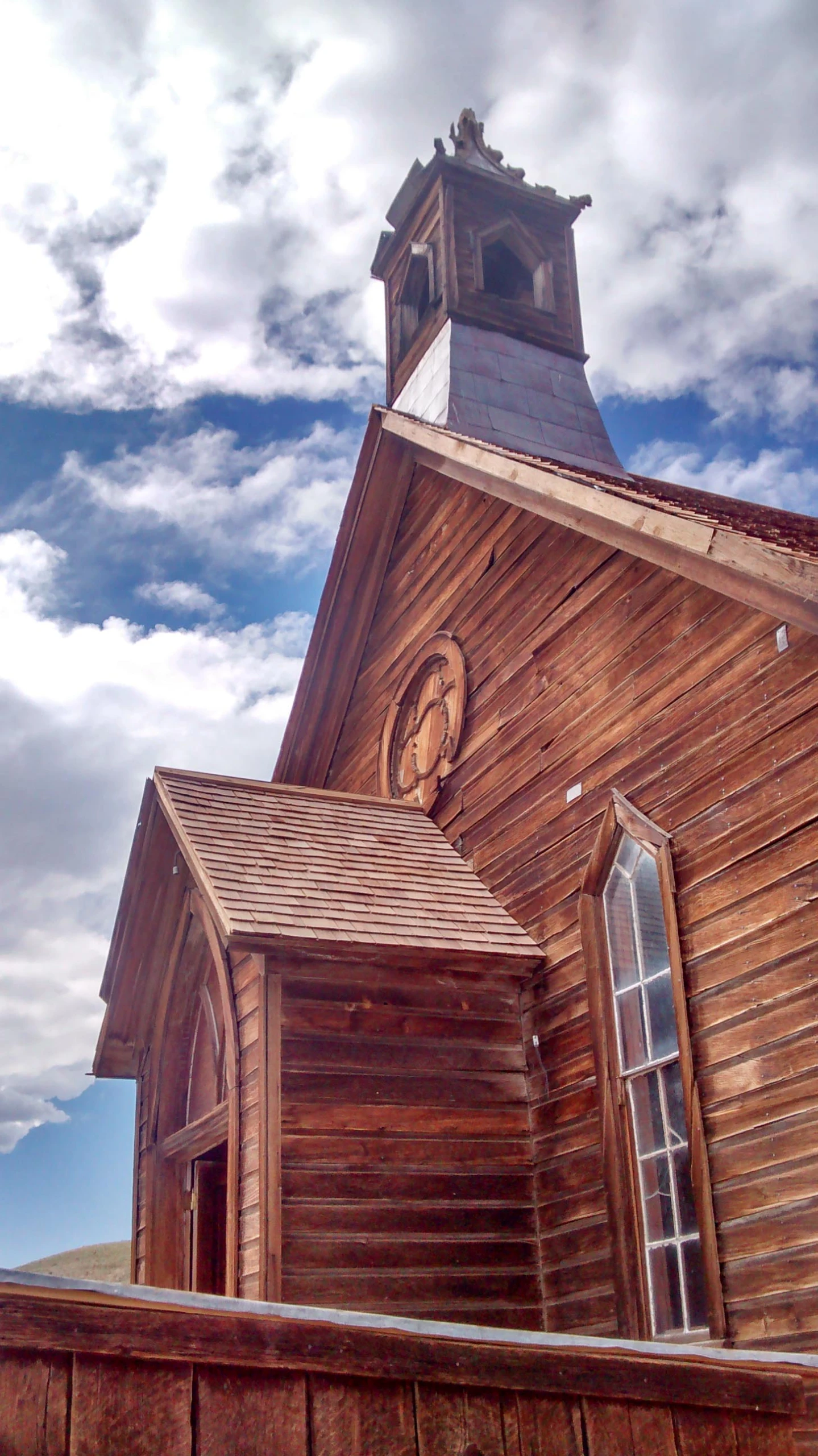 this is a wooden church with a tall steeple