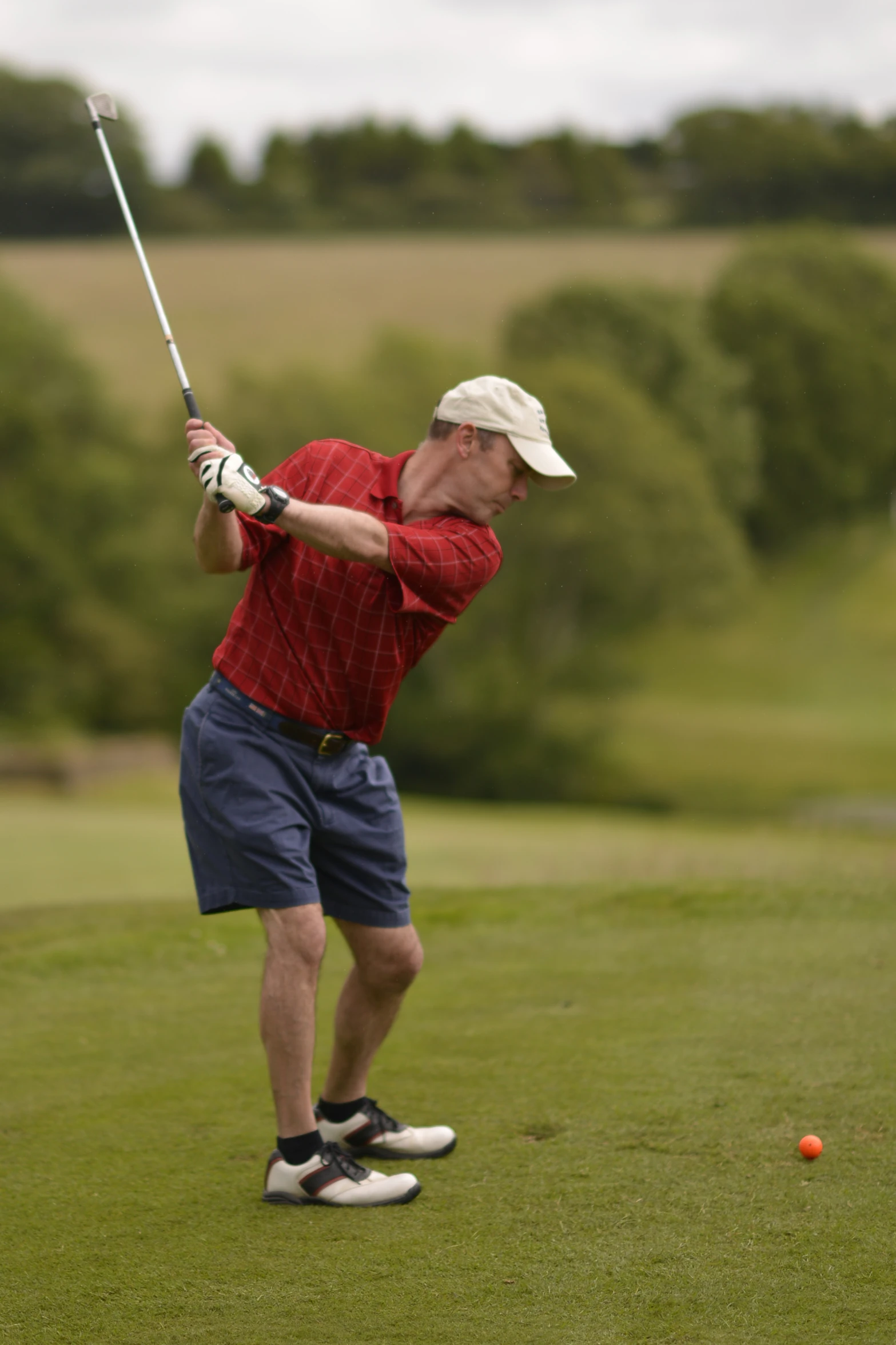 a man standing on top of a green field