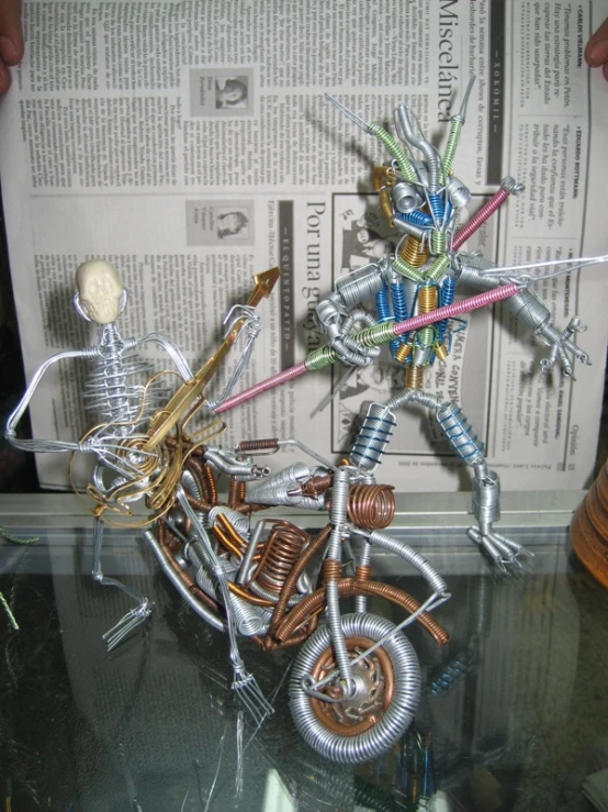 an action figure made out of metal sitting on a table