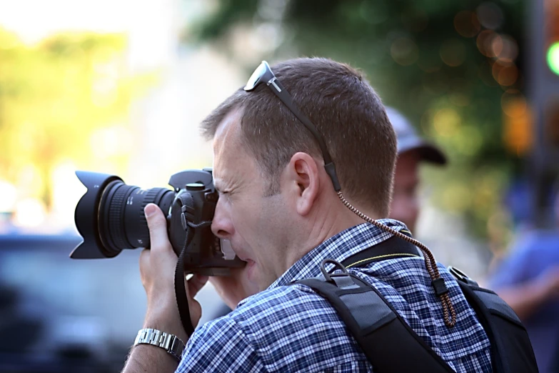 there is a man holding a camera and taking a picture