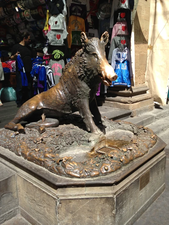 there is a bronze statue of a dog on a pedestal