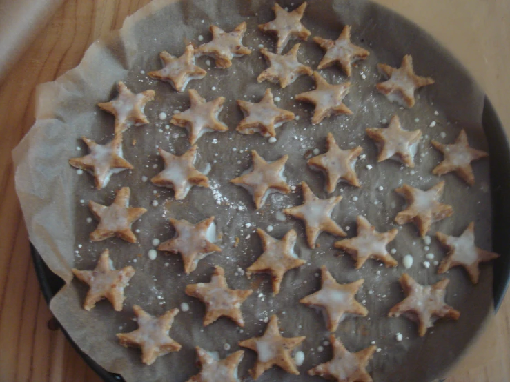 a pan filled with christmas stars cookies on top of a counter