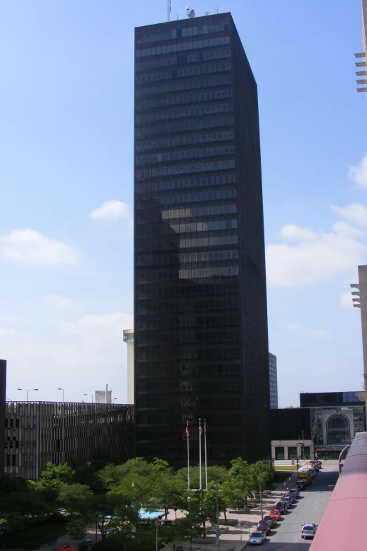 two black buildings next to each other with cars parked in front of it