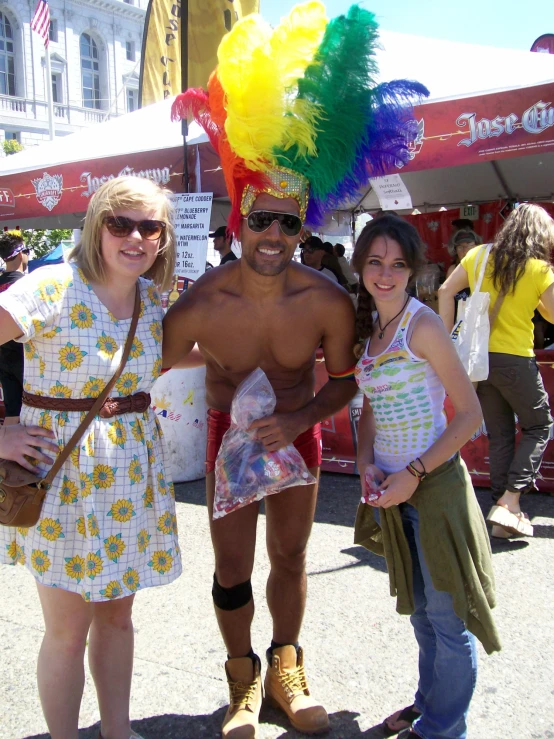 three people in a colorful party and a man is on the other side