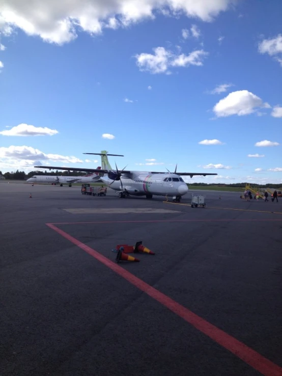 a plane sits on a runway at an airport