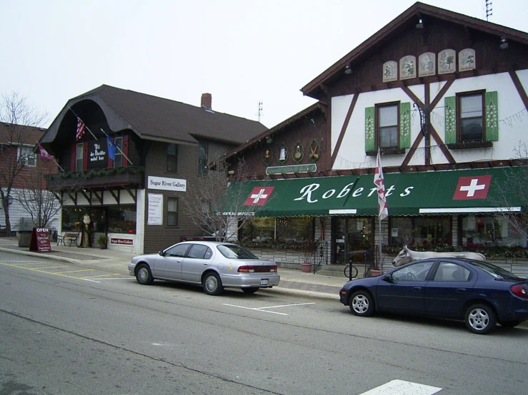 a city street scene with a storefront and cars parked on the side of the street