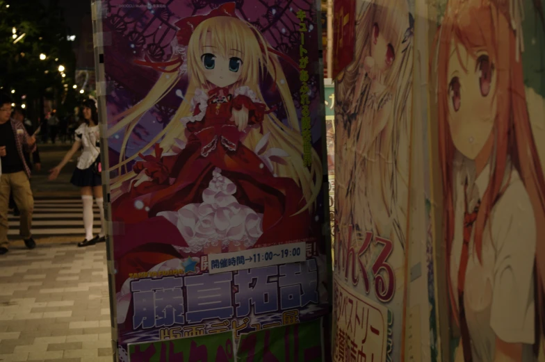 two anime character poster boards near each other