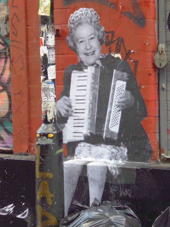 a person holding an accordion on a street