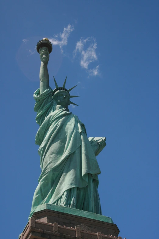 the statue of liberty stands on top of a building