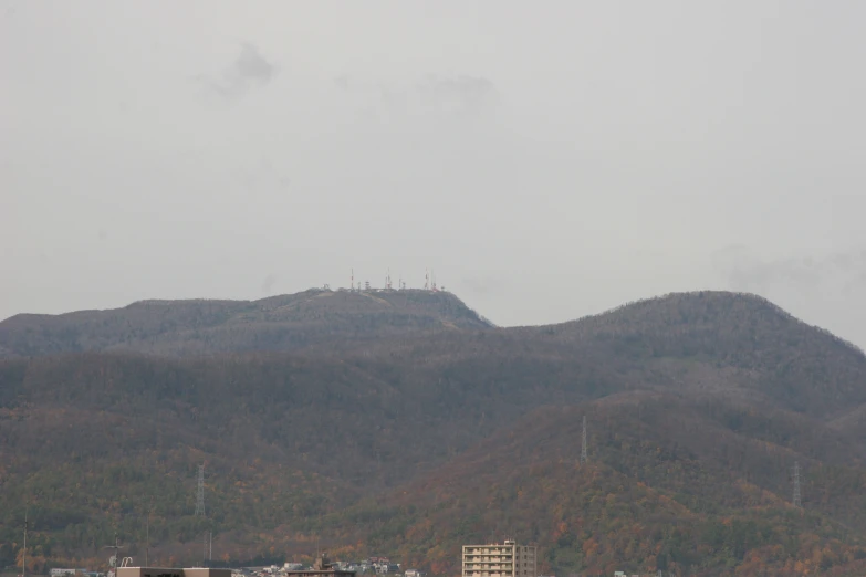 two hills and a few trees, with a large air plane in the foreground