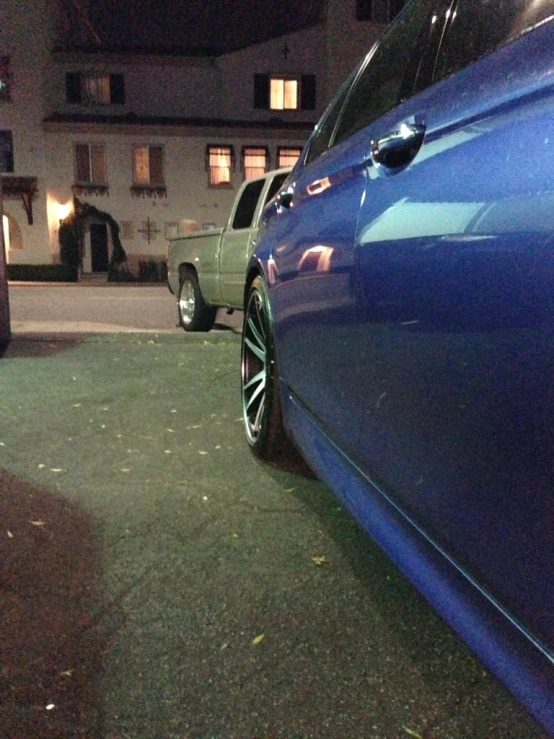 two blue vehicles parked side by side in front of a building