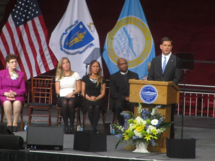 three people are standing in front of a podium