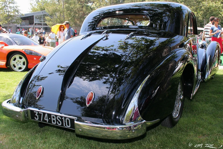 black classic car parked on a grass covered field