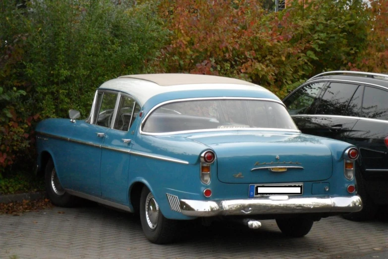 a blue car with an older style roof