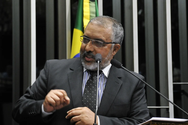 a man that is at a microphone giving a speech