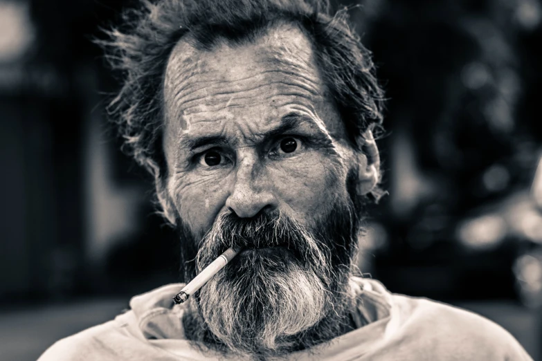 a close up of a person with a cigarette in his mouth