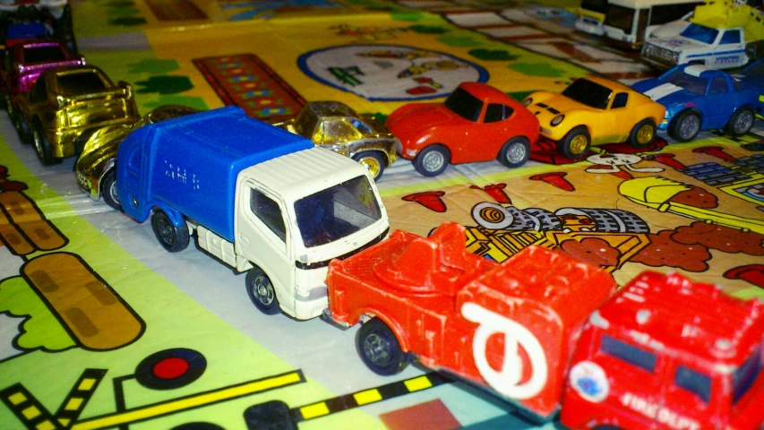 toys on colorful carpet with vehicles and cars