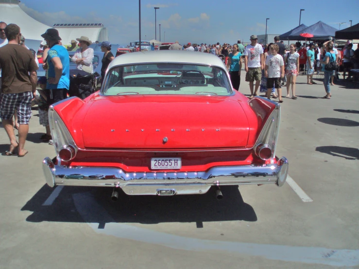 a red car is parked in a parking lot