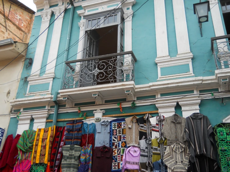 a building with a balcony and clothes drying from it's balconies