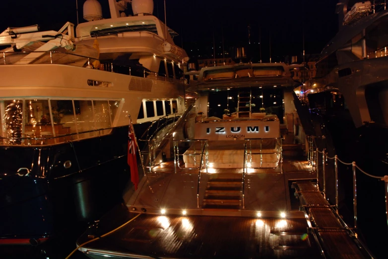 several boats are sitting docked at night in the water