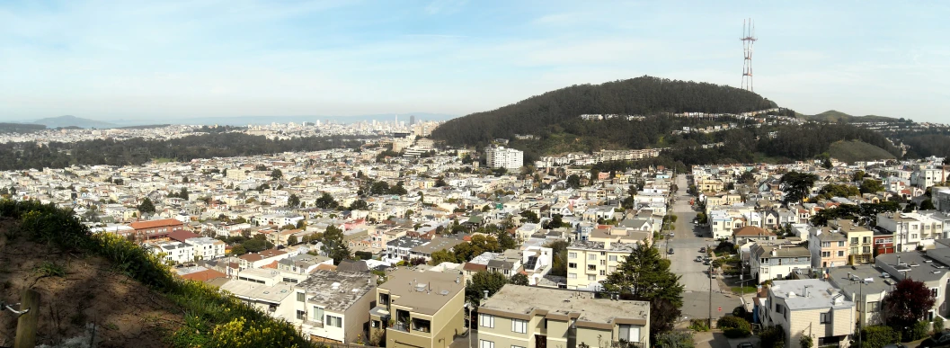 an urban area with a large hill in the background