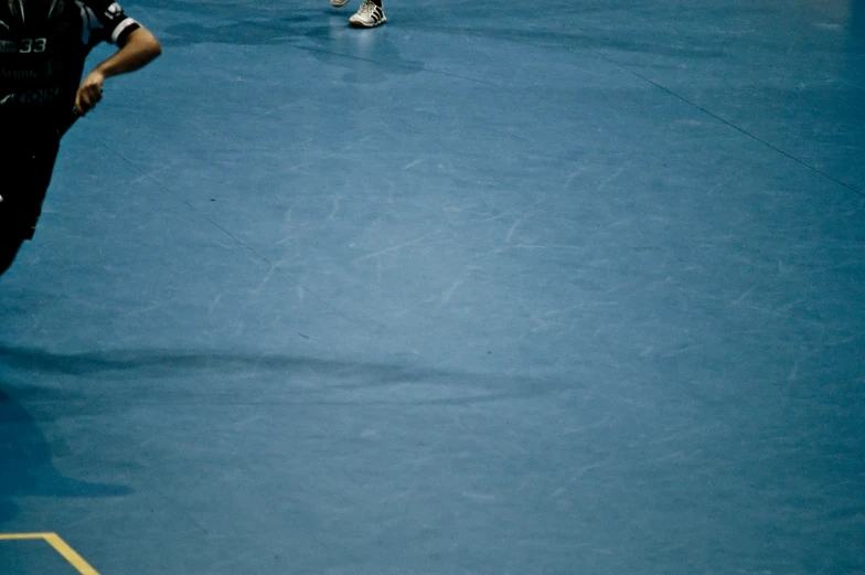 a tennis player holding his racket while a court is under construction