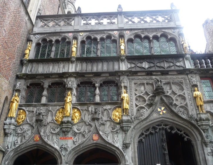 the architecture of an old building with statues on it