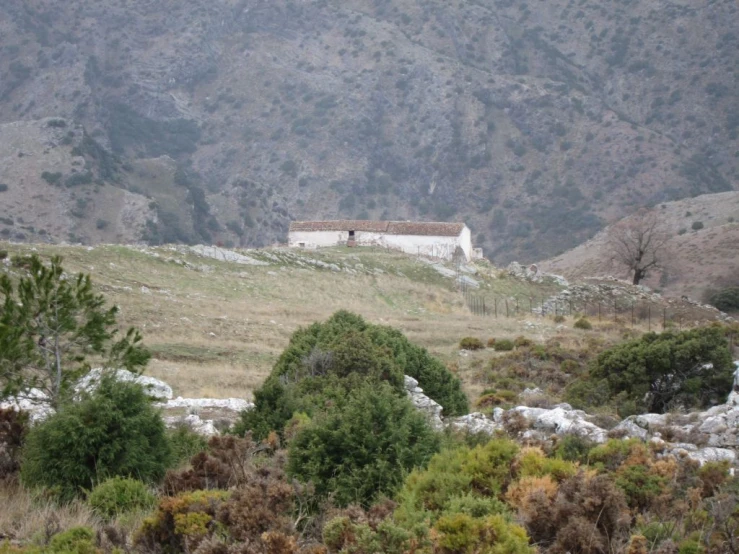 an image of house sitting on top of a mountain