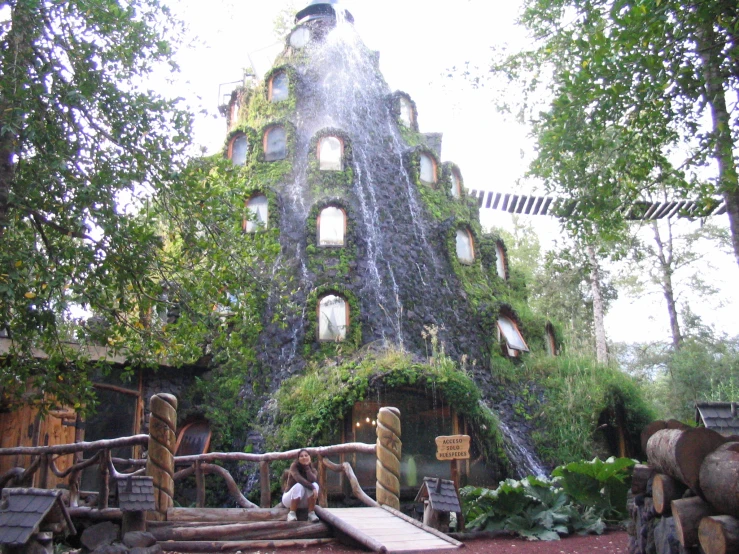 a large building with a waterfall falling into it