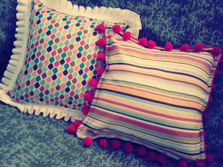 three pillows with colorful colored designs on them