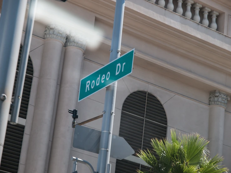 a green street sign attached to a pole