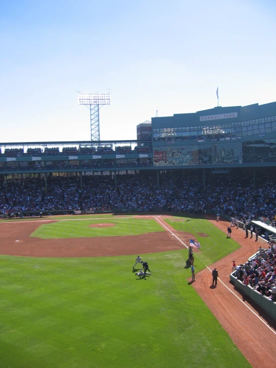 a crowd is watching a baseball game at a field