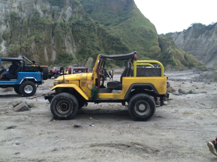 a yellow truck with a red backlight is sitting in the mud