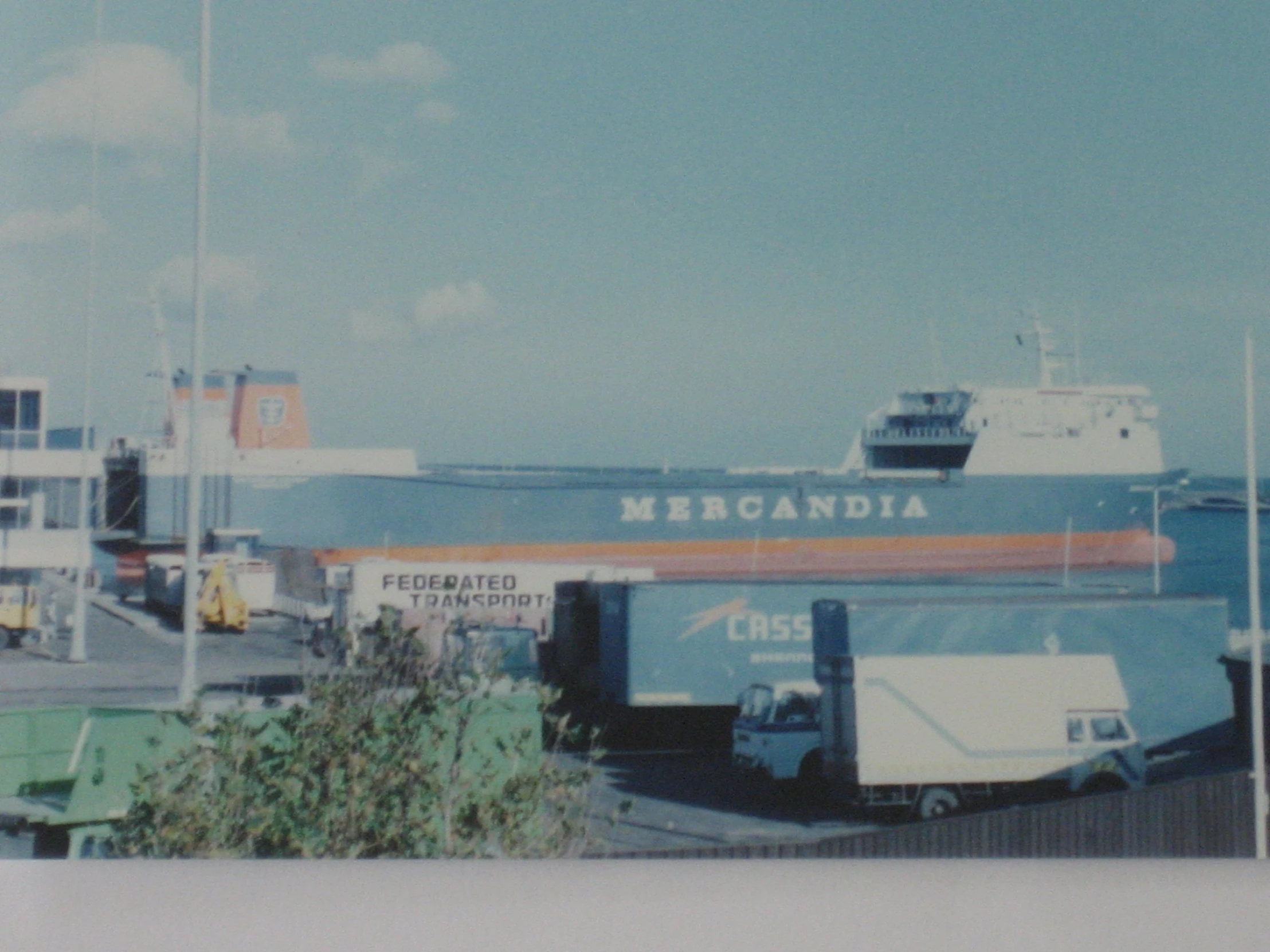 the boats are parked at the dock by the building