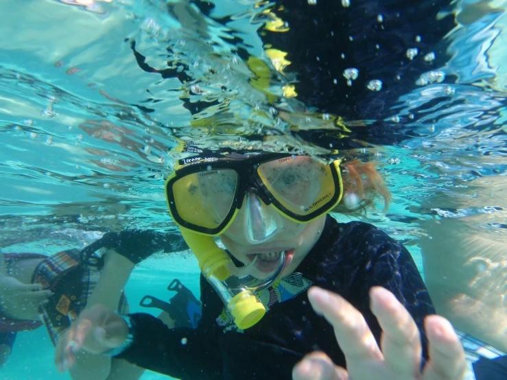 a person under the water with their hands in the air