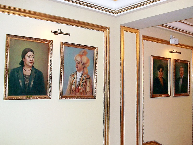 a wall in the lobby displaying old pographs of women in uniform