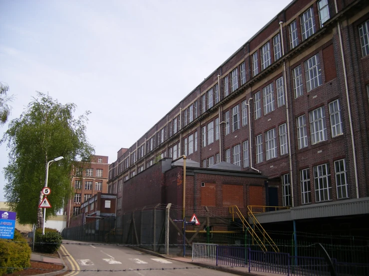 an empty street leading to some very large buildings