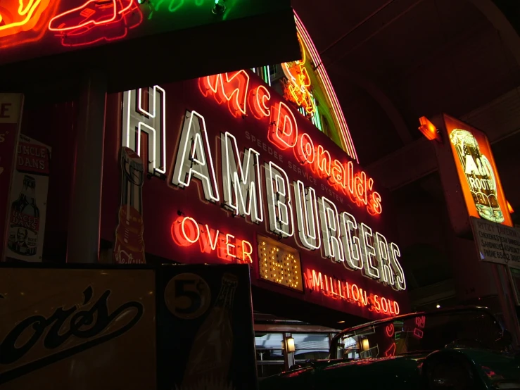 a neon sign sitting in front of a bar
