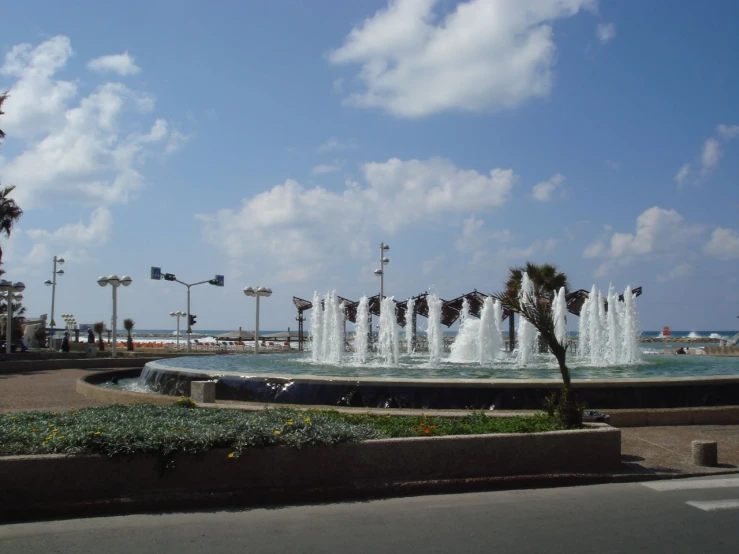 a water fountain on a city street corner