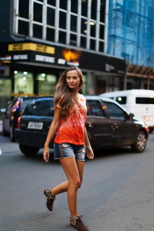 a beautiful young lady walking down a busy street
