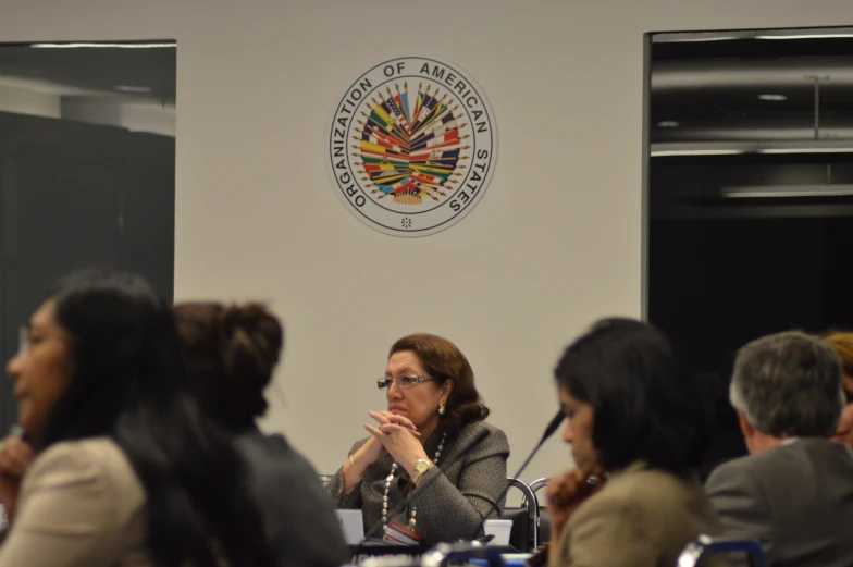 a woman in glasses is sitting at a table