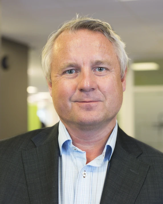 a man with short hair is smiling for the camera