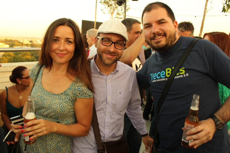 there are two people posing together with some drinks