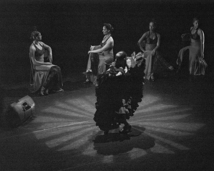 a group of people on stage in black and white