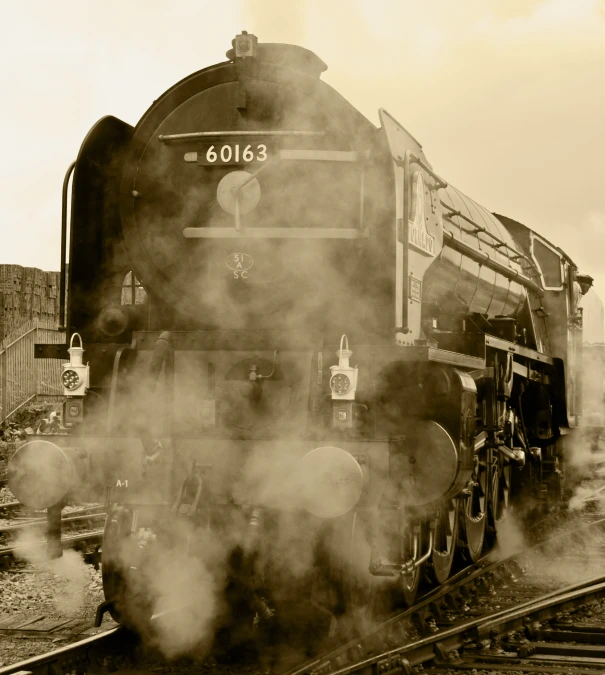 an old steam engine moving through the smoke from it