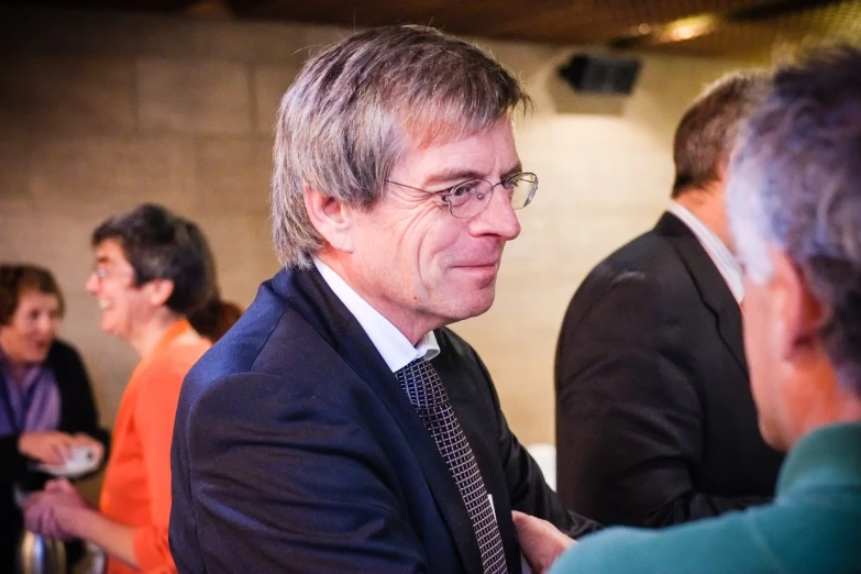 a man in a suit talking to an audience