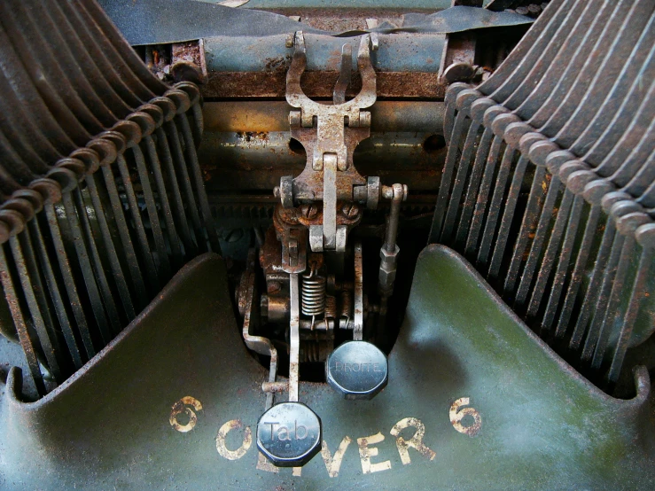 a typewriter is broken open and old, with metal plates