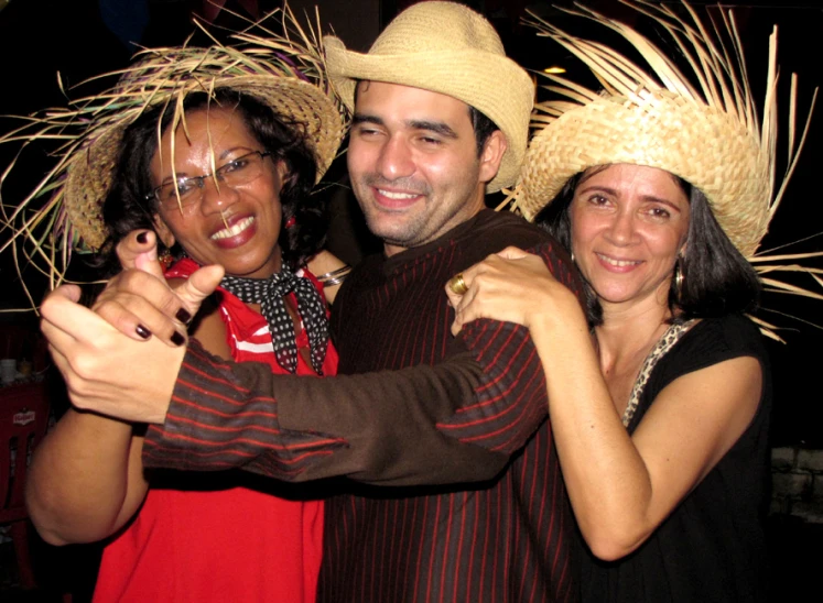 two people pose with their arms around another woman