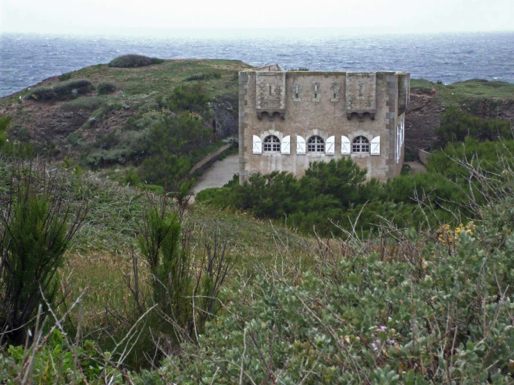 a house that is on a hill by the ocean