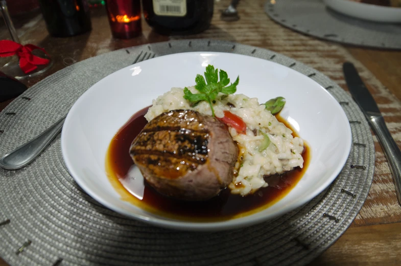 a white plate filled with meat and mashed potatoes